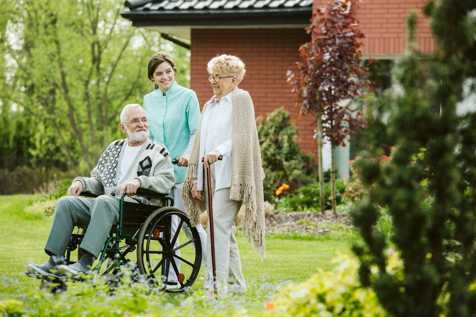 Senior man on the wheelchair in the garden of professional nursing home