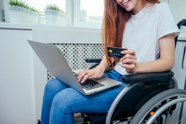 Confident happy redhaired ginger businesswoman student in wheelchair